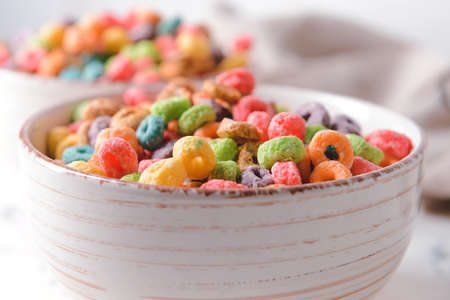Bowl with crunchy corn flakes rings on light background, closeupの写真素材