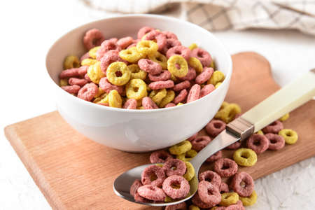 Bowl with crunchy corn flakes rings on tableの写真素材