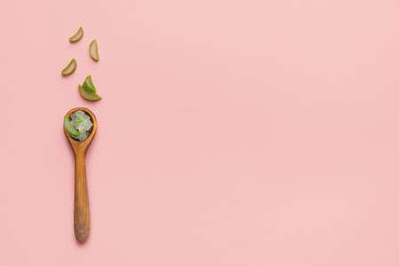Spoon with fresh cut aloe on color backgroundの写真素材