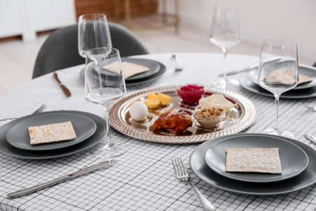 Passover Seder plate with traditional food on served tableの写真素材