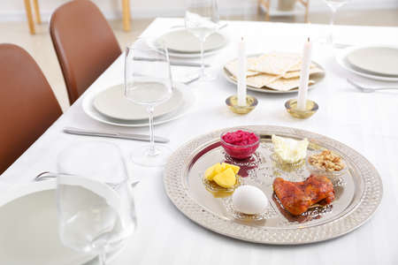 Passover Seder plate with traditional food on served tableの写真素材
