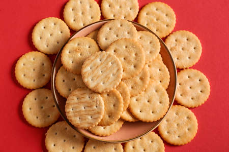 Bowl with tasty crackers on color backgroundの写真素材