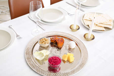 Passover Seder plate with traditional food on served tableの写真素材