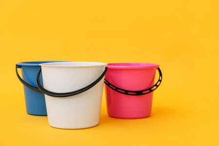 Plastic buckets on color backgroundの写真素材