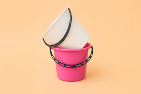 Plastic buckets on color backgroundの写真素材