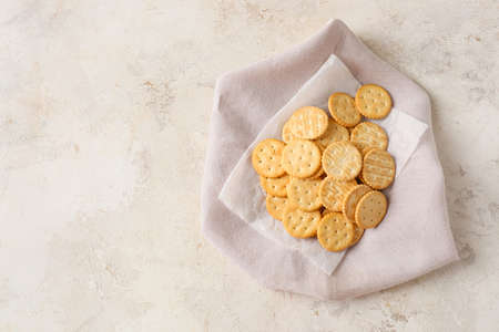 Tasty crackers on light background