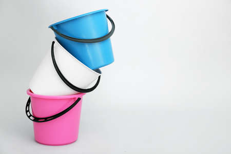Plastic buckets on light backgroundの写真素材