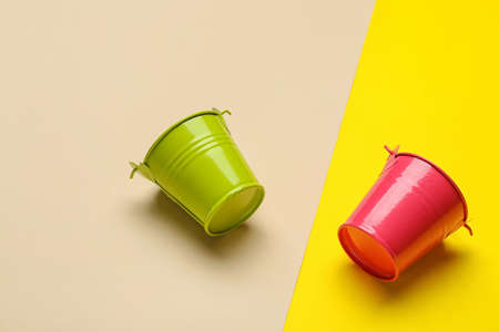 Metal buckets on color backgroundの写真素材