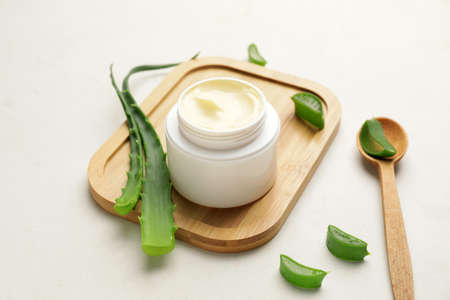 Natural cream with aloe leaves on light backgroundの写真素材