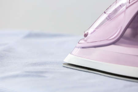 Electric iron and cloth, closeupの写真素材