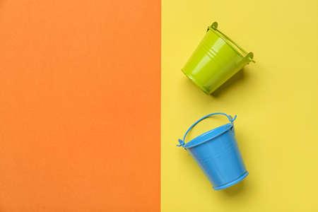 Metal buckets on color backgroundの写真素材