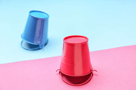 Metal buckets on color backgroundの写真素材