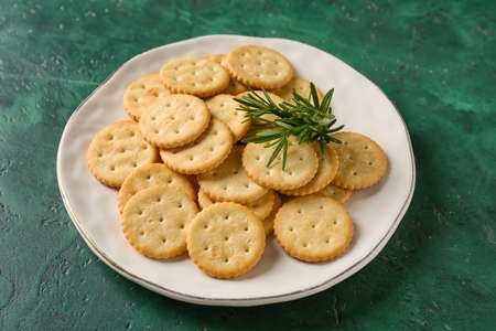 Plate with tasty crackers on color backgroundの写真素材