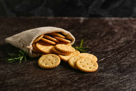 Bag with tasty crackers on dark backgroundの写真素材