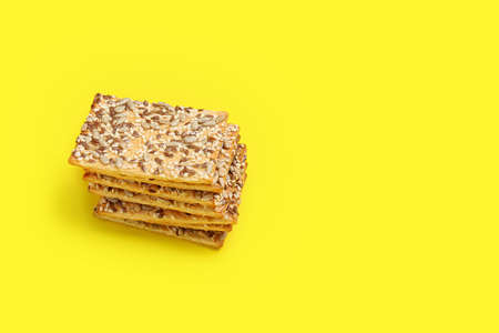 Tasty crackers with seeds on color backgroundの写真素材