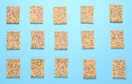 Tasty crackers with seeds on color backgroundの写真素材