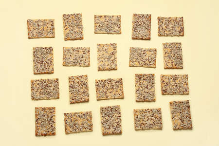 Tasty crackers with seeds on color backgroundの写真素材
