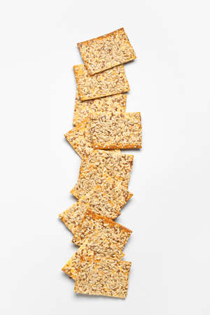 Tasty crackers with seeds on white backgroundの写真素材