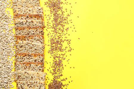 Tasty crackers with seeds on color backgroundの写真素材