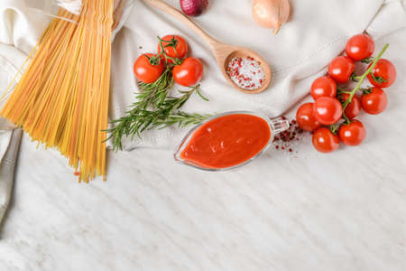 Gravy boat with organic tomato sauce on light backgroundの写真素材