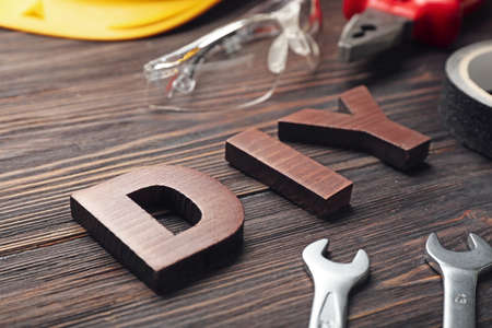 Set of tools and word DIY on wooden background, closeupの写真素材