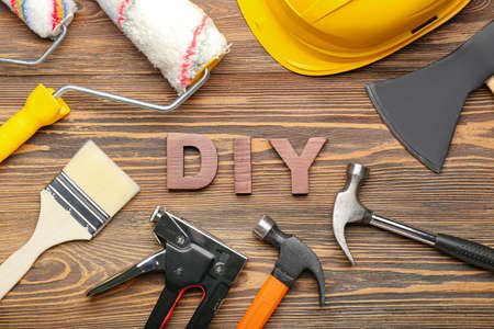 Frame made of tools and word DIY on wooden backgroundの写真素材