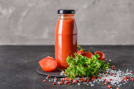 Bottle with organic tomato sauce on grunge backgroundの写真素材