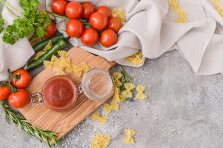 Jar with organic tomato sauce on grunge backgroundの写真素材