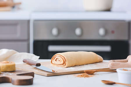 Preparing of tasty cinnamon rolls in kitchen