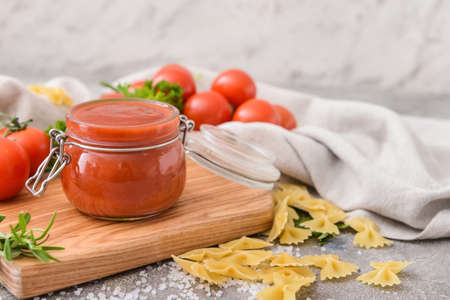 Jar with organic tomato sauce on grunge backgroundの写真素材