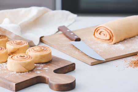 Preparing of tasty cinnamon rolls in kitchen
