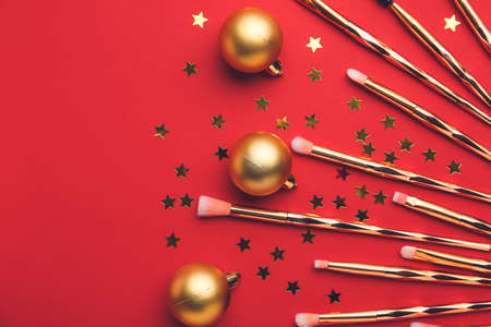 Composition with makeup brushes and Christmas decor on color backgroundの写真素材