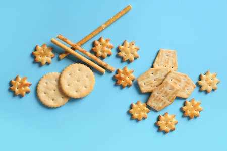 Tasty different crackers on color backgroundの写真素材