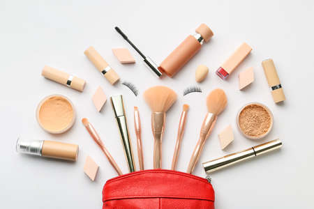 Decorative cosmetics and makeup brushes on light backgroundの写真素材