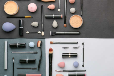 Decorative cosmetics and makeup brushes on dark backgroundの写真素材