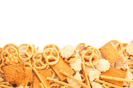 Tasty different crackers on white background