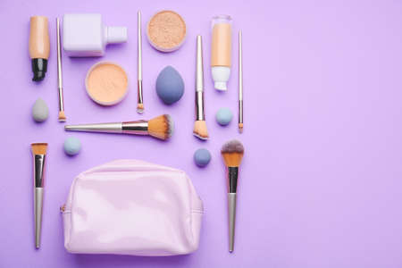 Decorative cosmetics and makeup brushes on color backgroundの写真素材