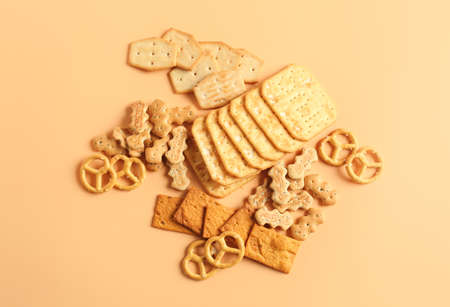 Tasty different crackers on color backgroundの写真素材