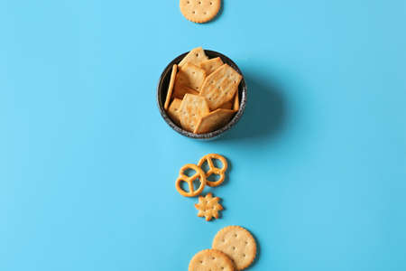 Bowl with tasty different crackers on color backgroundの写真素材