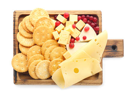 Board with tasty crackers, cranberries and cheese on white backgroundの写真素材