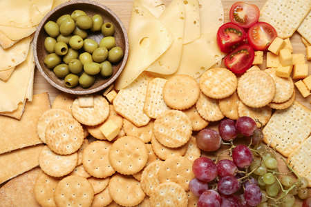 Board with tasty crackers with cheese and snacks, closeupの写真素材