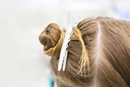Female head with hair clip in salon, closeupの写真素材