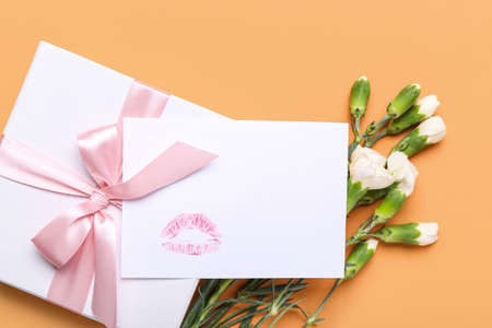 Beautiful gift with empty card on color backgroundの写真素材