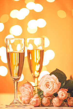 Glasses of champagne and beautiful flowers on table. Valentine's day celebrationの写真素材