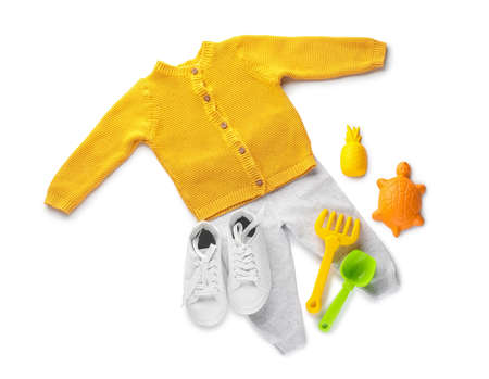 Children's clothes and toys on white backgroundの写真素材