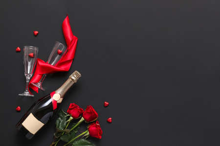 Composition with champagne and flowers for Valentine's Day on dark backgroundの写真素材