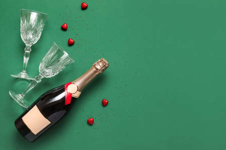 Bottle of champagne and glasses on color background. Valentine's day celebrationの写真素材