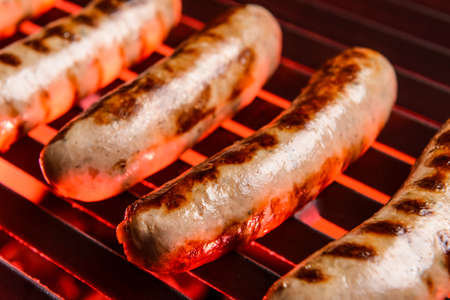 Delicious sausages cooking on grillの写真素材