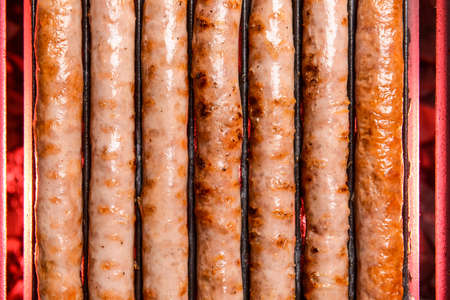 Delicious sausages cooking on grill, closeupの写真素材