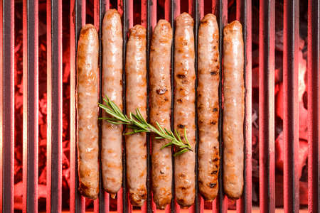 Delicious sausages cooking on grillの写真素材